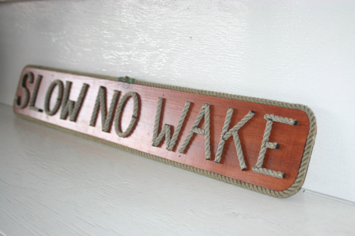 SLOW NO WAKE sign - Alaska Rug Company